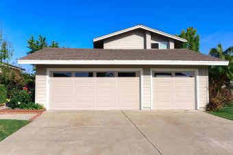 Exterior view of a cozy suburban house with a double garage, perfect for families.